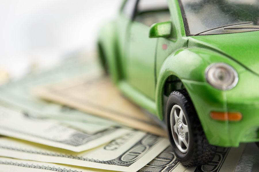 bigstock-toy-car-and-money-over-white-49217057